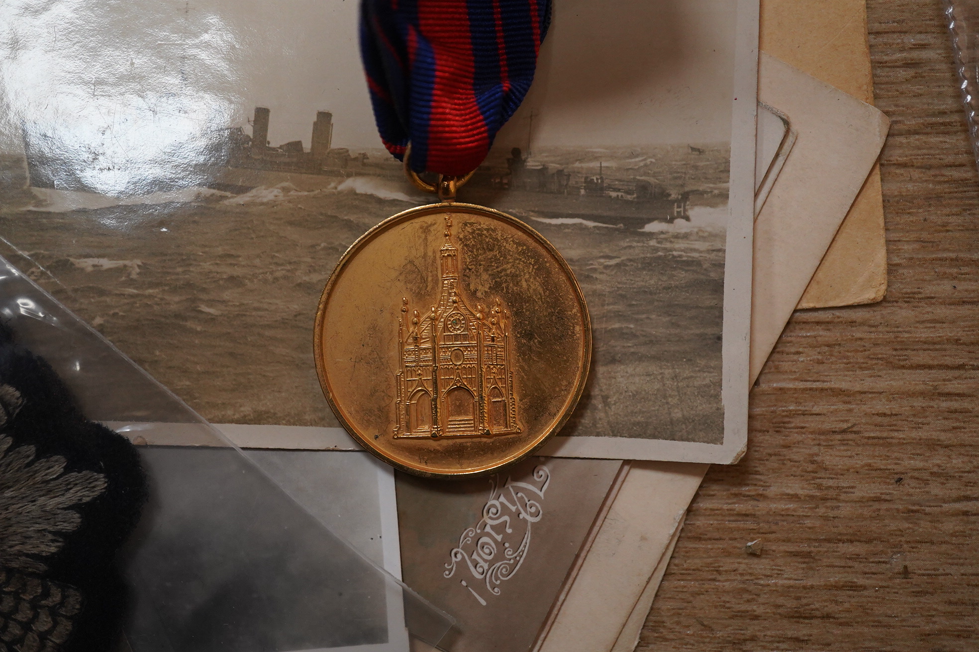 A quantity of various military ephemera to include a Coldstream guards matchbox holder, a death plaque and another 19th century glass plaque, buttons, badges, National Registration Identity Card, various photos and lette